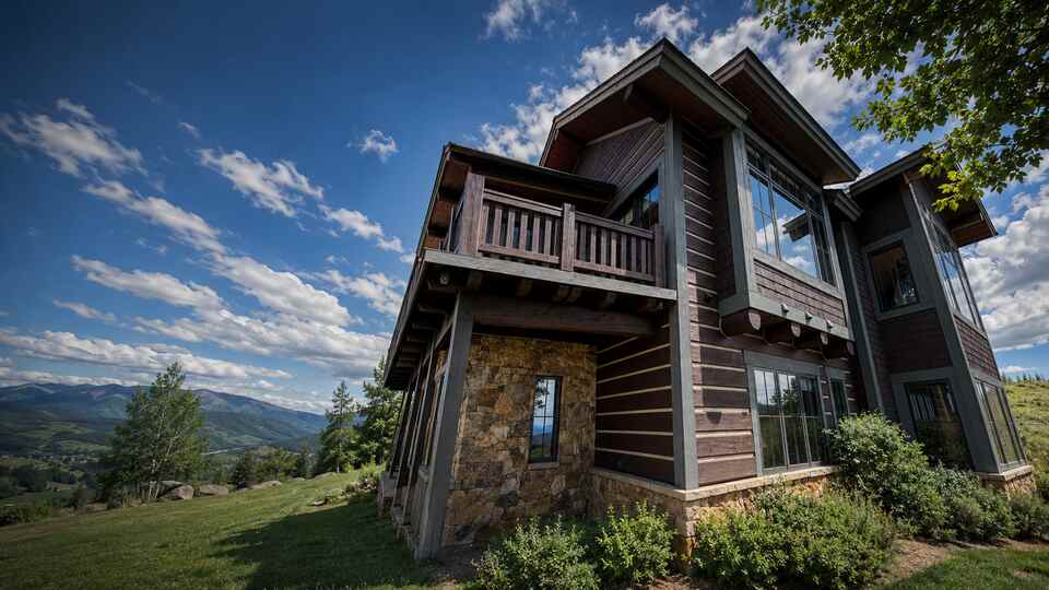 Luxury mountain home with dark wood siding painted by Maldonado's Painting in Eagle County